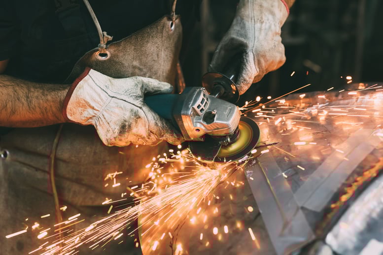 hands-of-metalworker-grinding-copper-in-forge-work-2022-03-07-23-55-48-utc-min