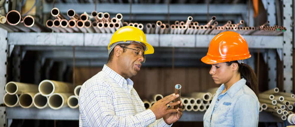 two-warehouse-workers-looking-at-copper-pipe-2022-03-04-01-48-40-utc-1